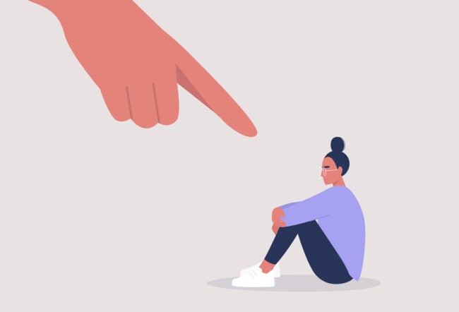 Illustration of a person sitting with knees drawn up, looking concerned, as a large finger points at them, symbolizing blame or accusation.