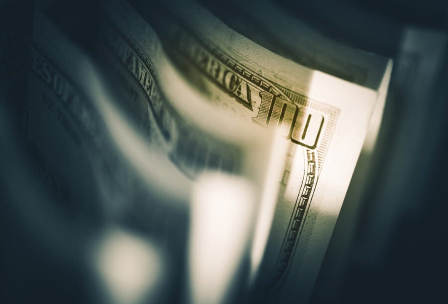 Closeup of a bunch of hundred dollar bills to show how Basel III Endgame would affect banks